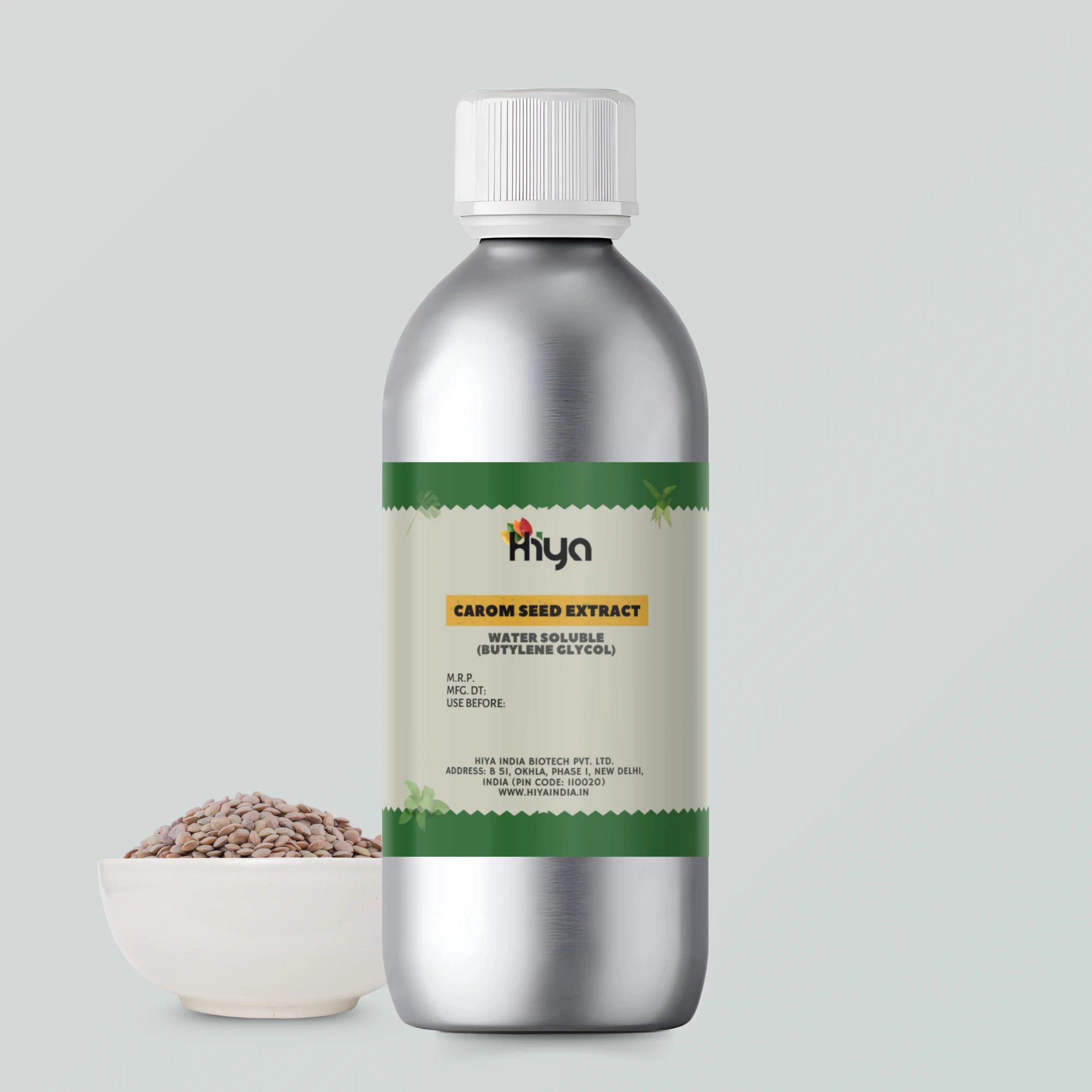 Metallic bottle of Hiya Carom Seed Extract, labeled ‘Water Soluble (Butylene Glycol),’ placed beside whole carom seeds in a white bowl.