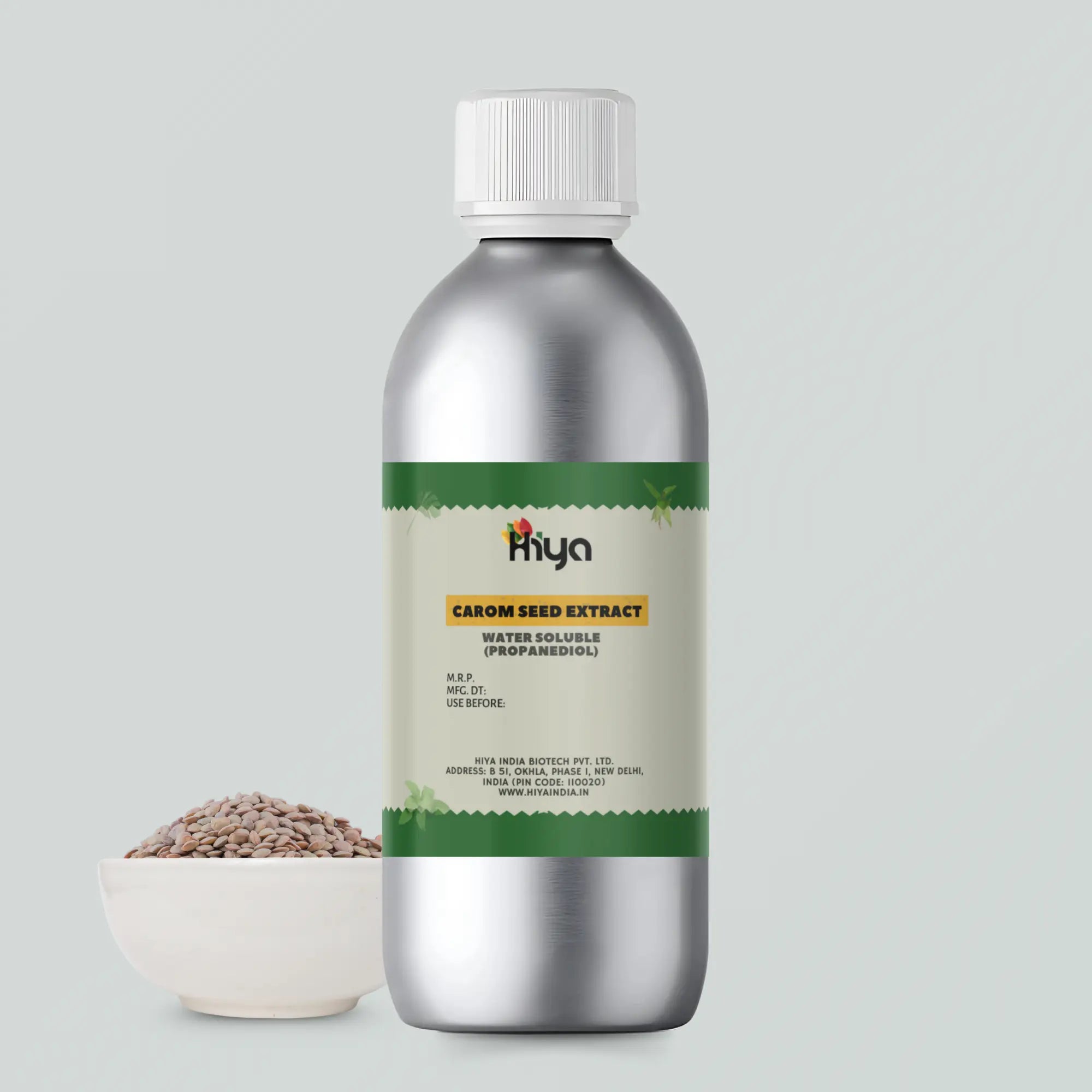 A metallic silver bottle labeled - Hiya Carom Seed Extract Water Soluble Propanediol with a small bowl of carom seeds beside it.
