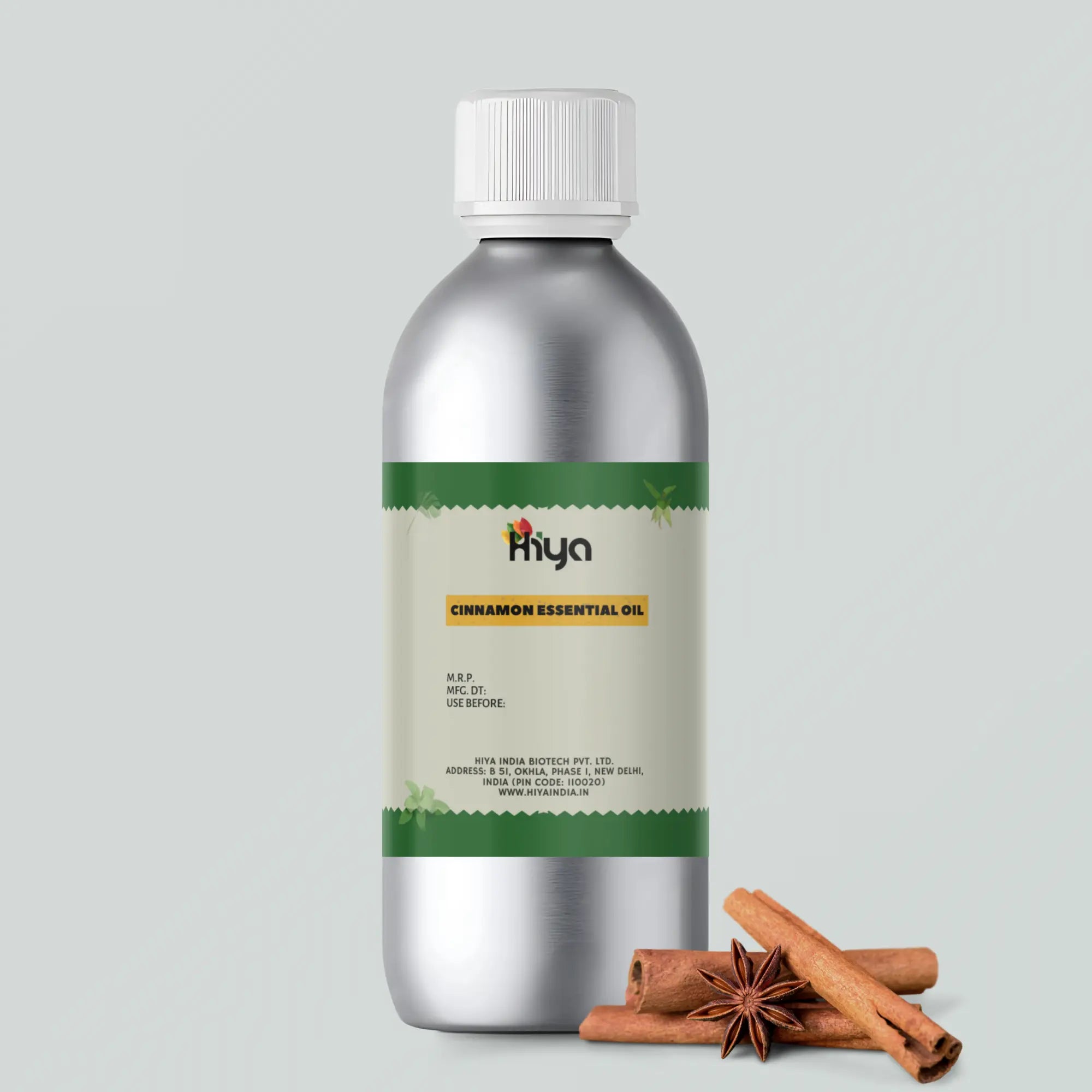 Hiya India Cinnamon Essential Oil in a metallic bottle with white cap, placed beside two cinnamon sticks and a star anise.