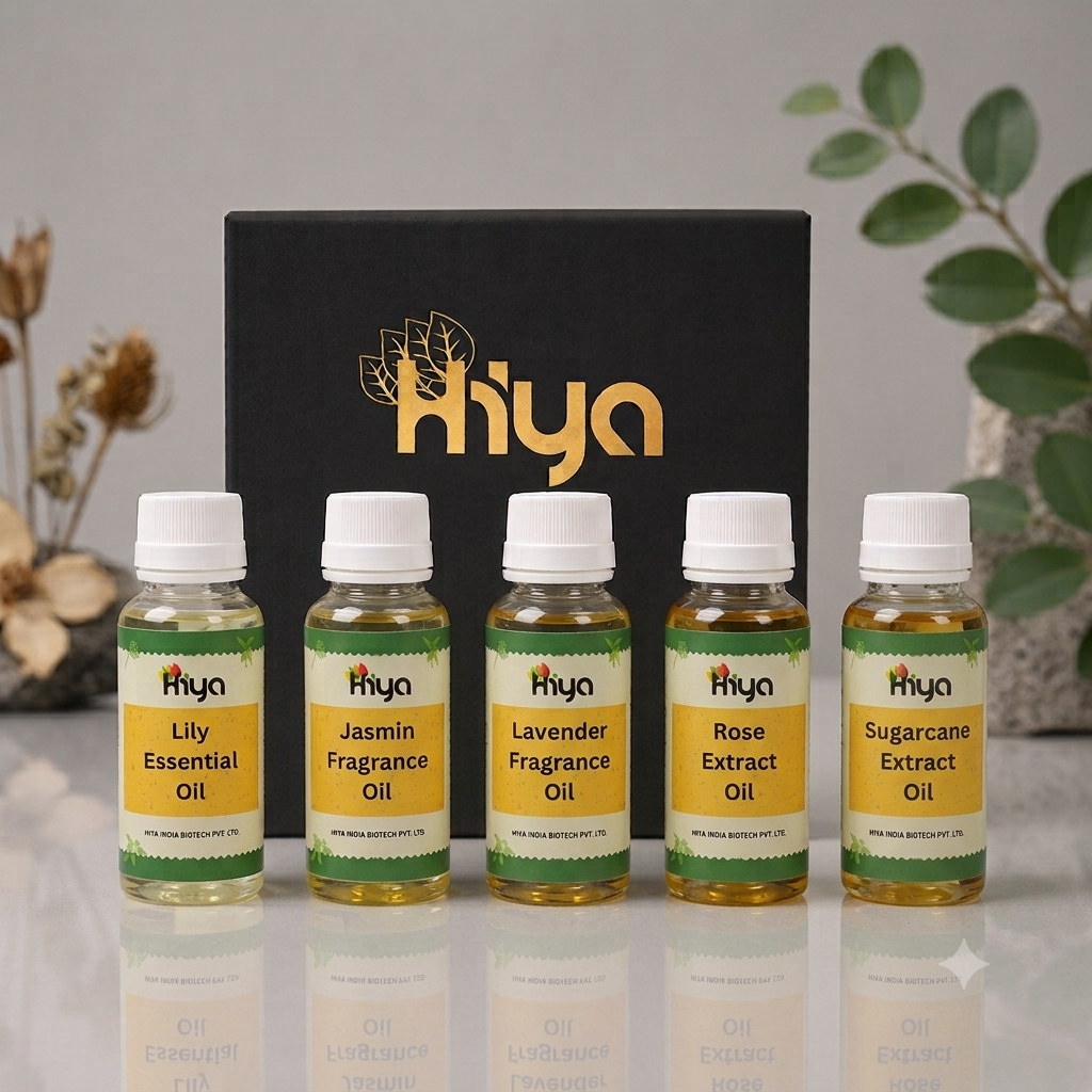 Five small bottles of Hiya oils arranged in front of a black branded box on a light gray surface, with decorative dried flowers and green leaves in the background.