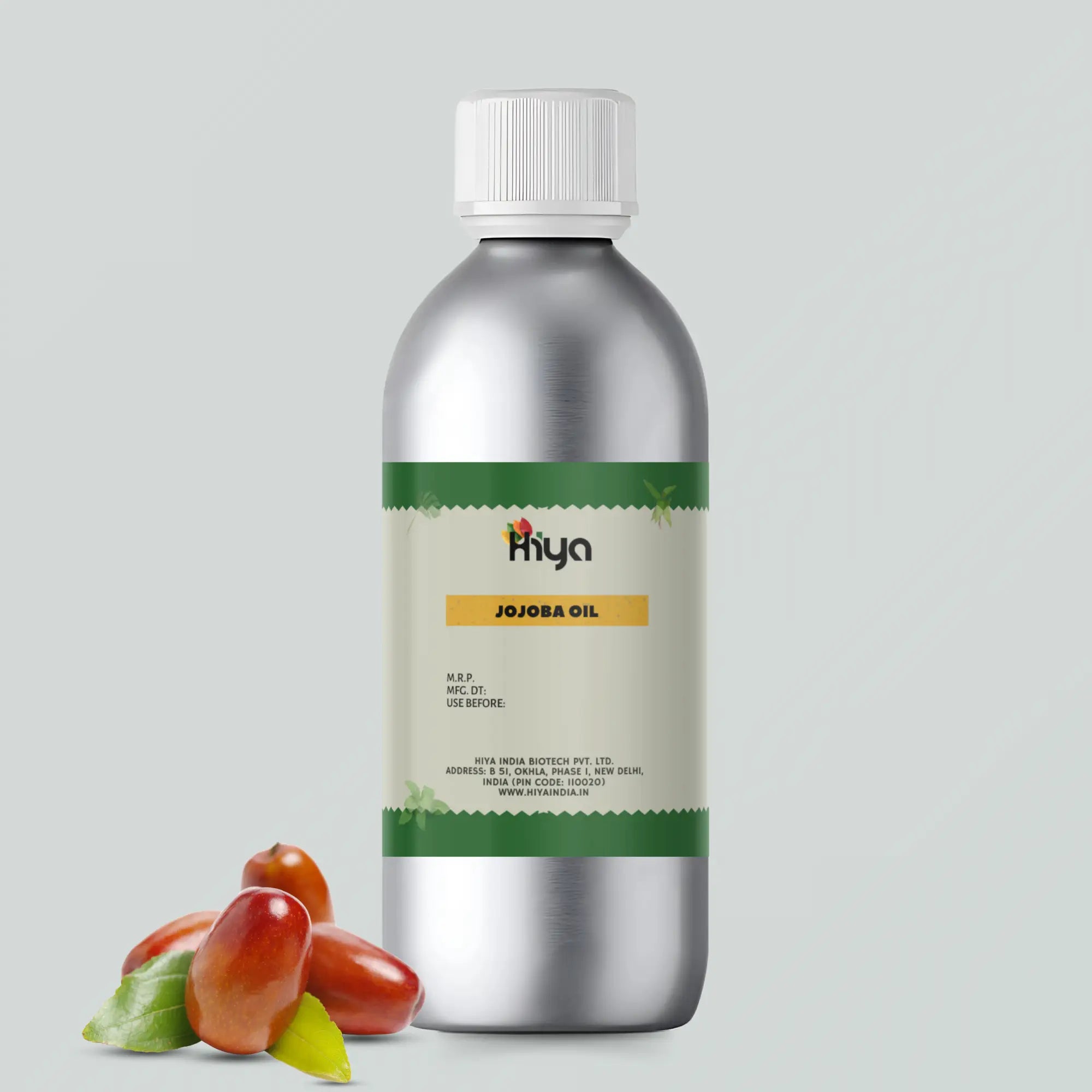 A metallic bottle labeled 'Hiya Jojoba Oil' with a white cap. The label displays the product name, price, manufacturing date, expiry date, and company details. Next to the bottle, there are three jojoba seeds with green leaves.