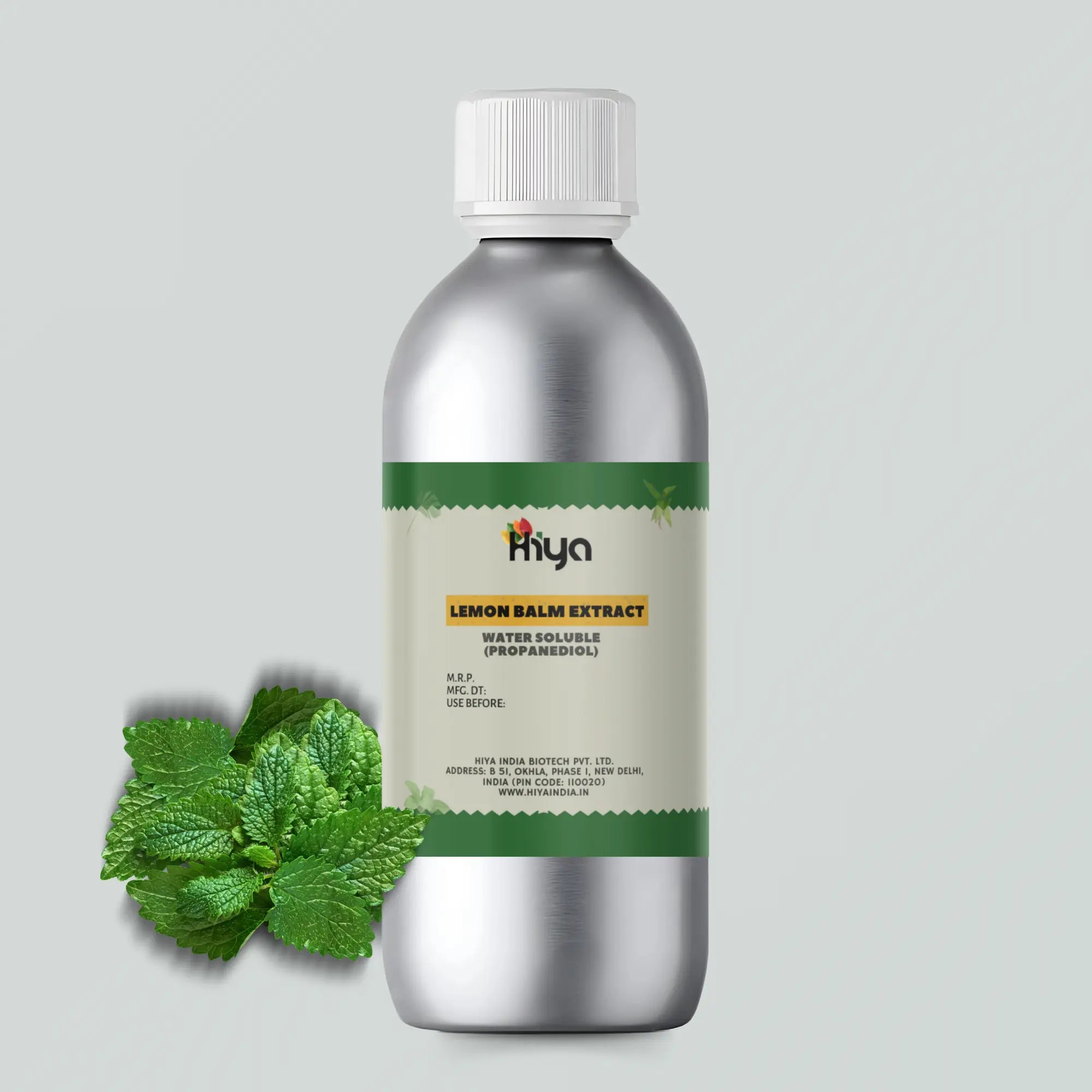 A metallic bottle labeled "Hiya Lemon Balm Extract Water Soluble (Propanediol)" stands upright. Beside the bottle, a cluster of fresh lemon balm leaves is arranged.