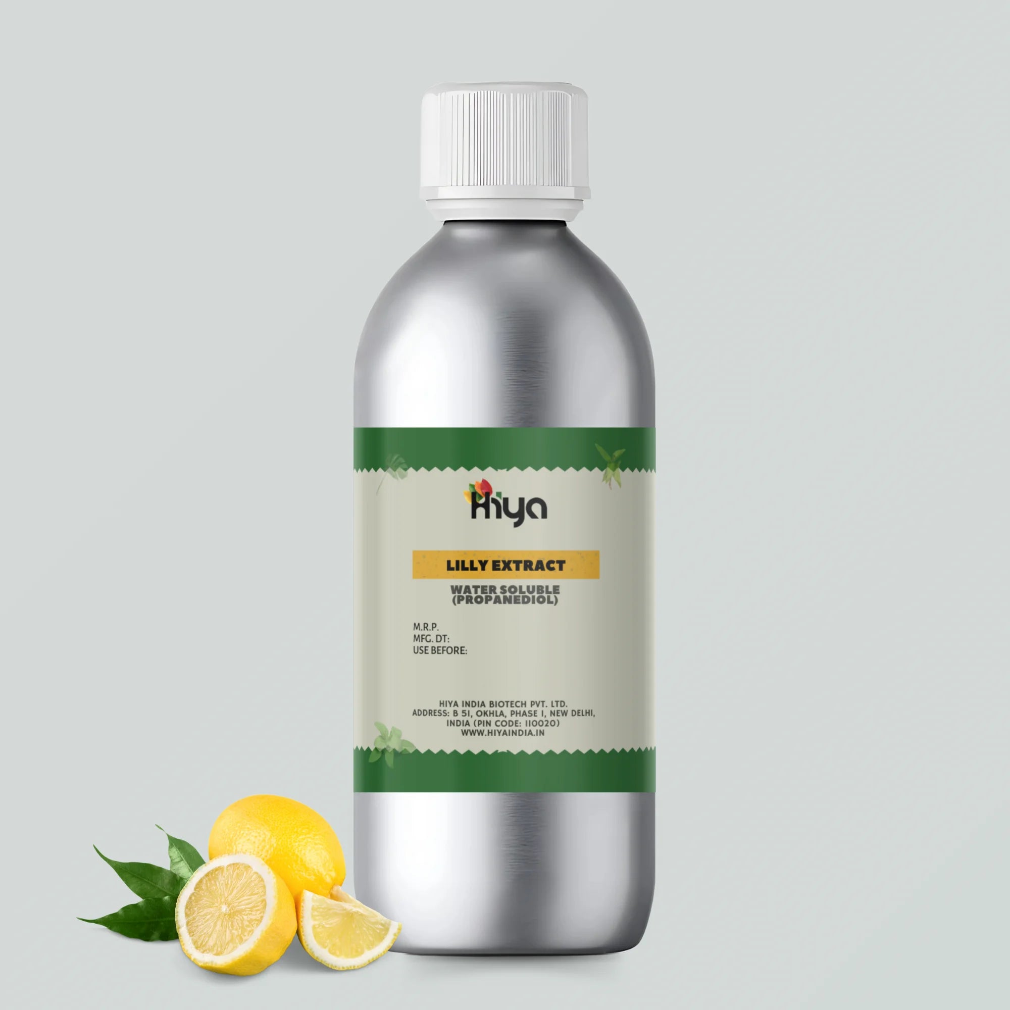A metallic bottle labeled "Hiya Lilly Extract Water Soluble (Propanediol)" with a white cap and a green and beige label. The label contains product details, including the manufacturer’s information and expiry date. Two lemons and a lemon slice are placed beside the bottle, highlighting a fresh, natural theme.