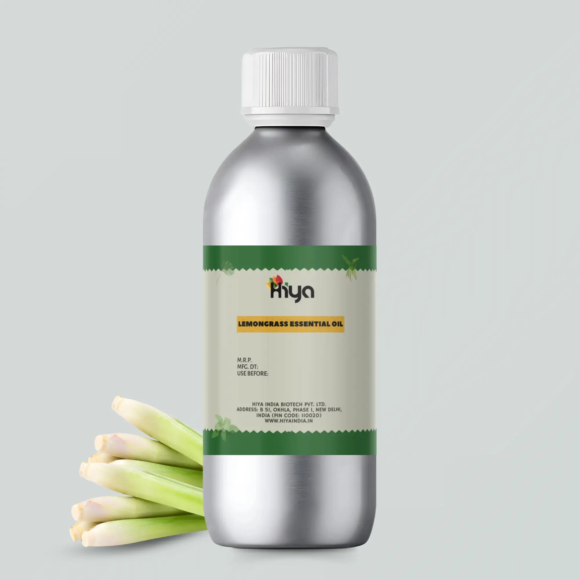 A silver bottle with label 'Lemongrass Essential Oil' along side of a pile of lemongrass with lite gray background.