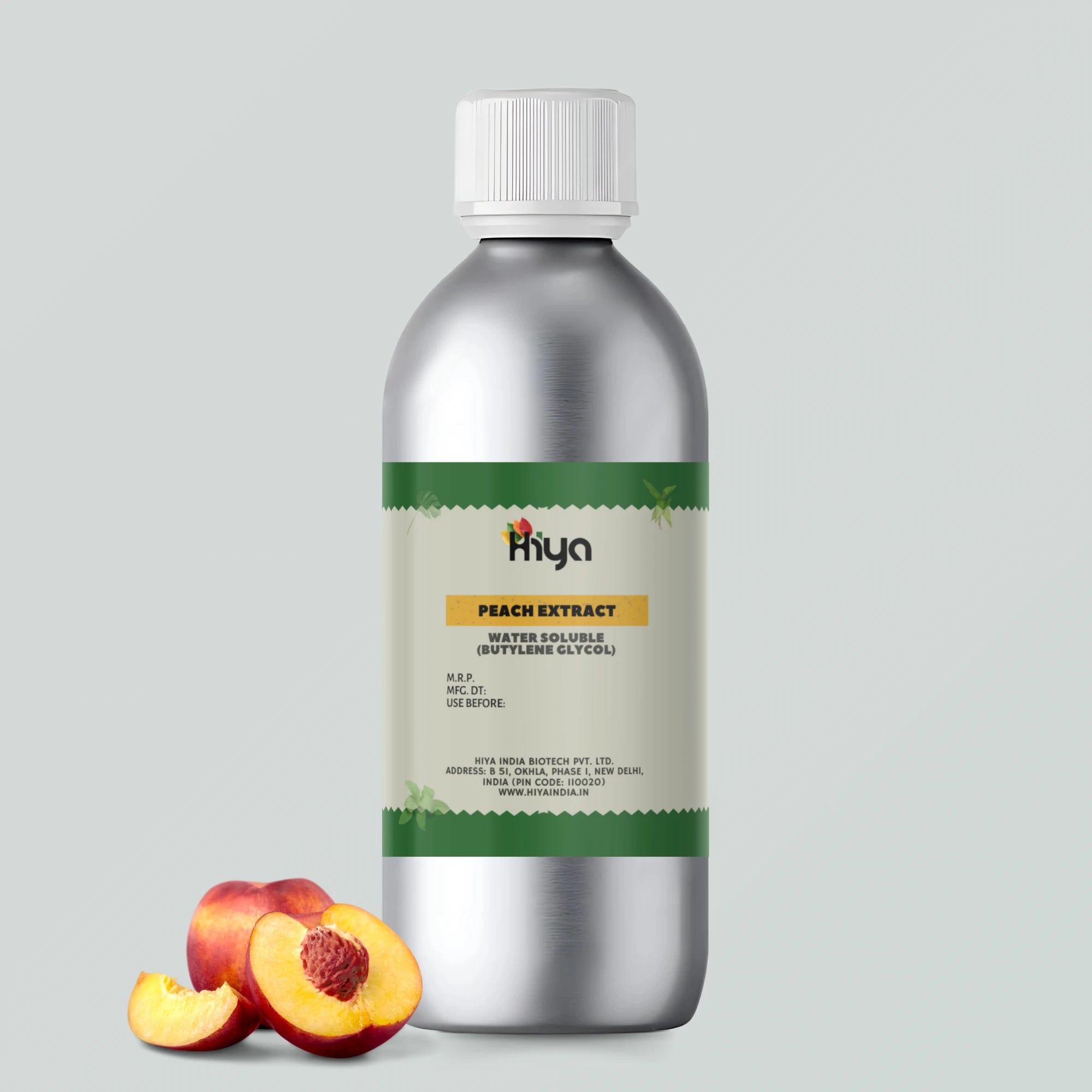 A metallic bottle labeled 'Hiya Peach Extract Water Soluble (Butylene Glycol),' placed against a soft gray background. A whole peach and a sliced peach sit beside the bottle, highlighting its natural ingredients and fresh appeal. The label includes key details such as MRP, manufacturing date, expiration date, and the company’s website, reinforcing authenticity and brand trust.