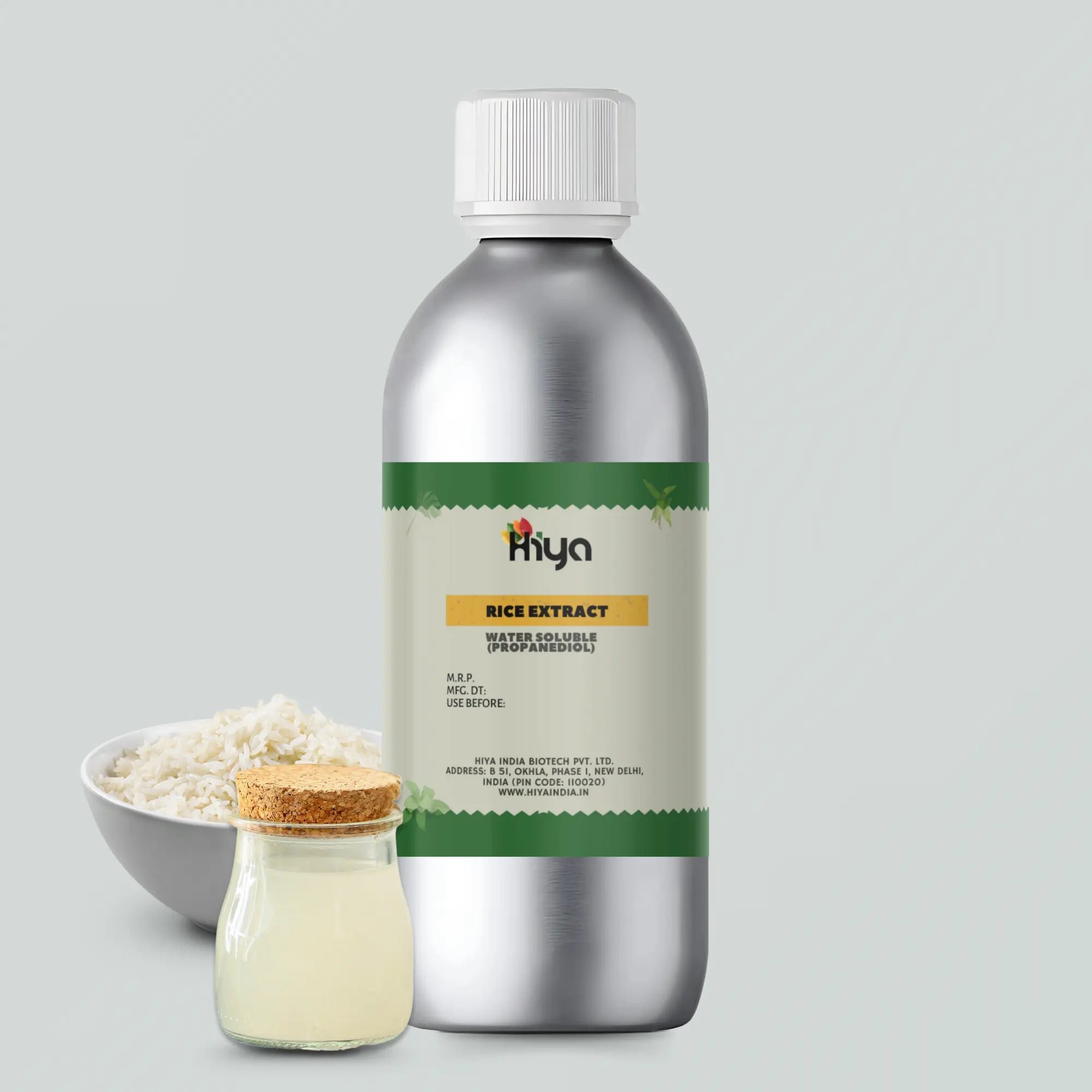 A Metallic bottle labeled "Hiya Rice Extract Water Soluble (Propanediol)" placed alongside a glass jar with liquid rice extract and a bowl of rice. 