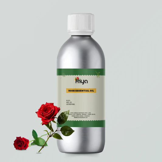 A metallic bottle labeled 'Hiya Rose Essential Oil,' featuring a white cap and green label with details like MRP, manufacturing date, expiration date, manufacturer (Hiya India Biotech Pvt. Ltd.), and website (www.hiyaindia.in). Two red roses with green leaves are placed in front of the bottle, visually emphasizing the product's rose essence.