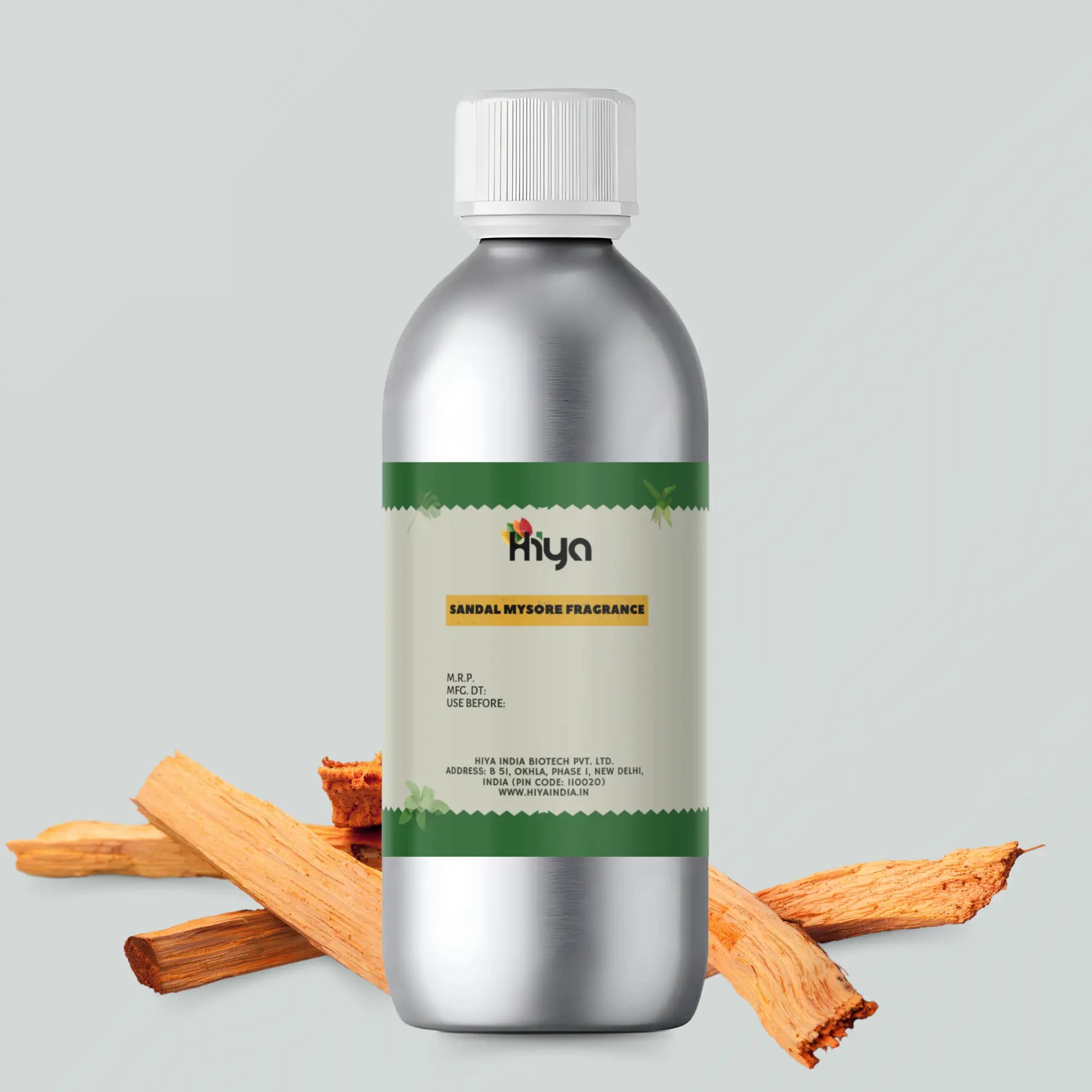 A silver aluminum bottle with a white cap labeled 'Hiya Sandal Mysore Fragrance.' Pieces of sandalwood are arranged around the bottle to highlight the product's essence.