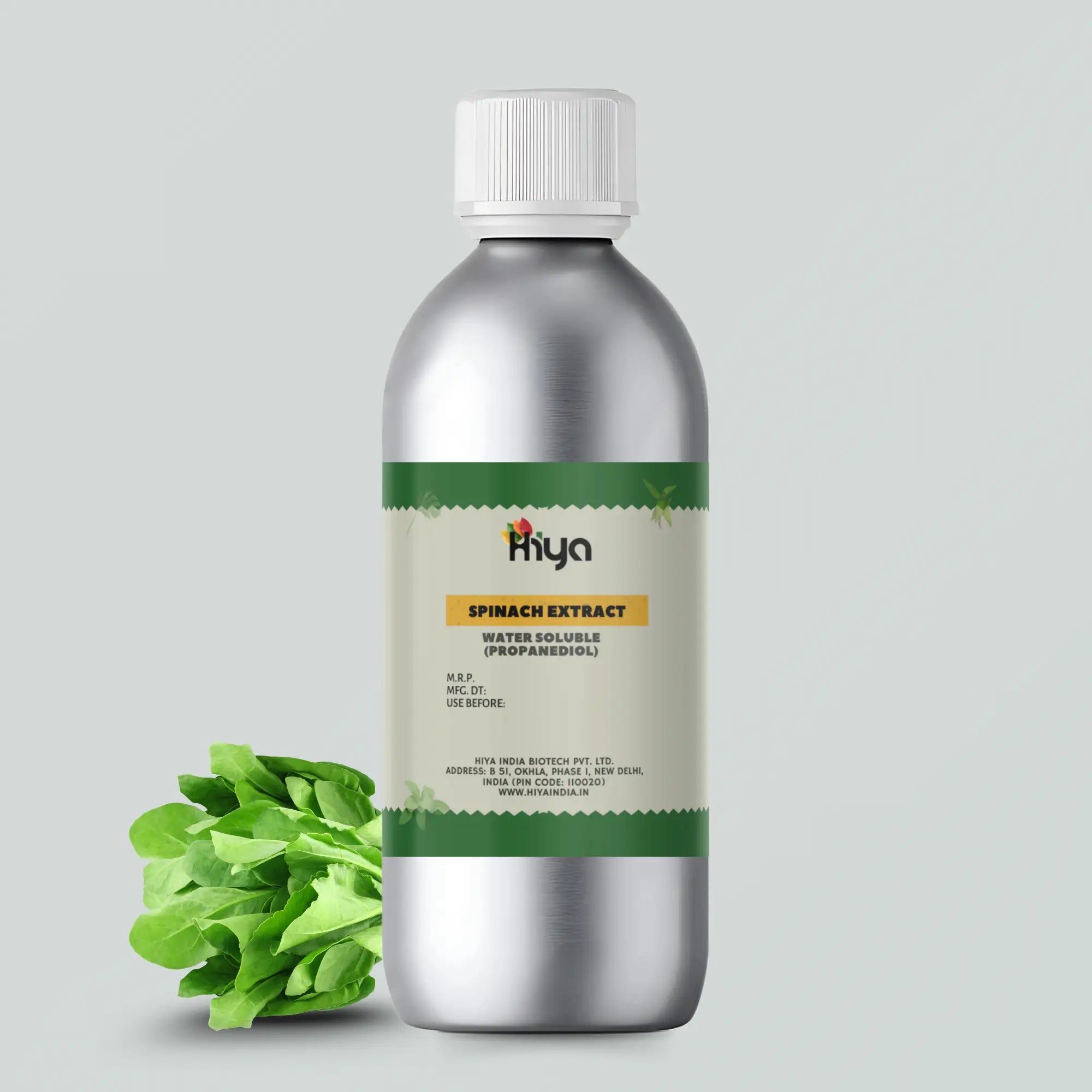 A silver aluminum bottle labeled "Hiya Spinach Extract Water Soluble (Propanediol)" with fresh spinach leaves beside it.